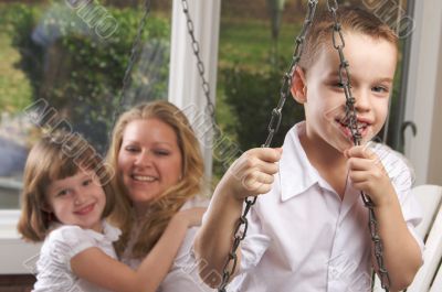 Young Boy Poses with Mom and Sister