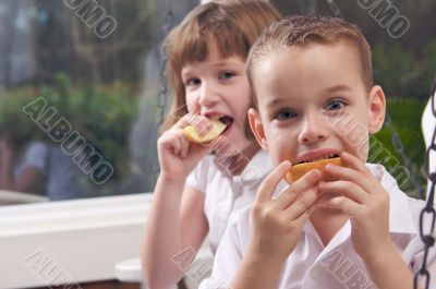 Sister and Brother Eating an Apple