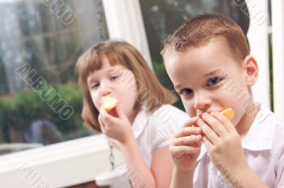 Sister and Brother Eating an Apple