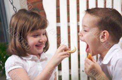 Sister and Brother Eating an Apple