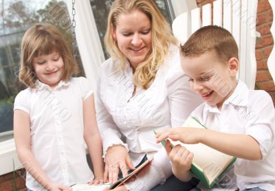 Young Boy Reads to His Mother and Sister