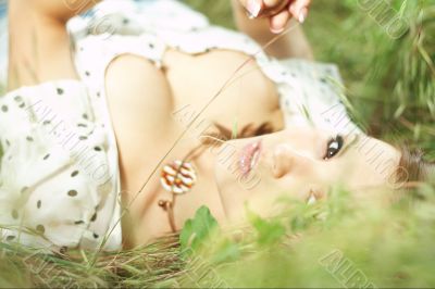girl lying down of grass
