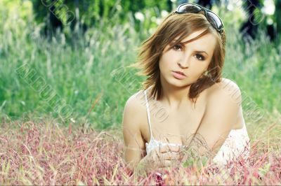 girl lying down of grass