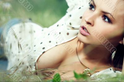 girl lying down of grass