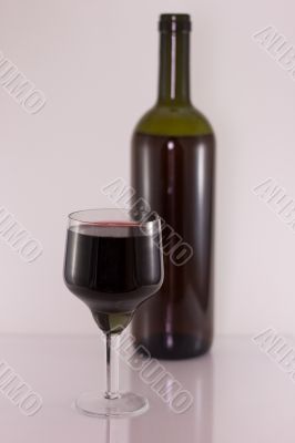 Glass and bottle with red wine