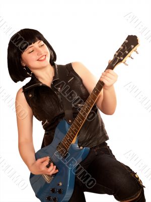 Young woman plays on a guitar