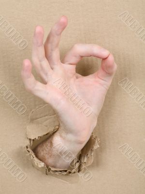 Gesture male hand through cardboard
