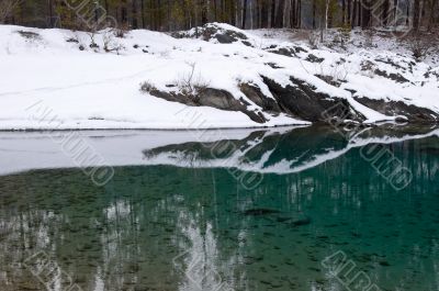 Rocky coast of nonfreezing blue lake