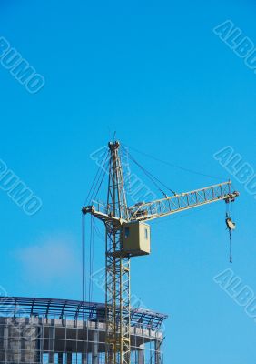 Lifting construction crane at blue sky