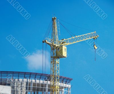 Lifting construction crane at blue sky