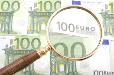 magnifying glass with money close up
