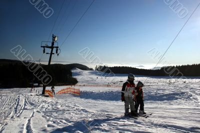 Cable lift with two skiers