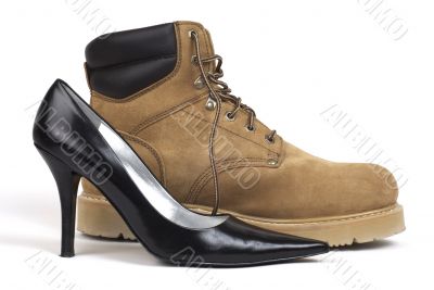 Side Shot of Black Women`s High-Heel Shoe Beside Workboot