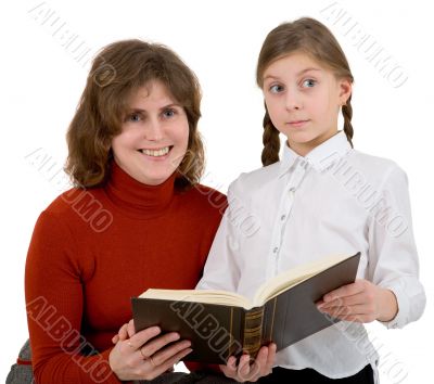 Woman with girl reading book