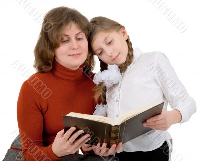 Woman with girl reading book