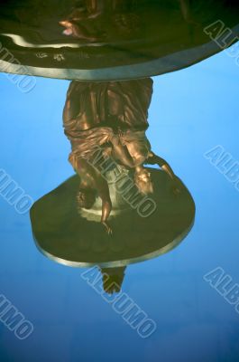 statues reflected on water