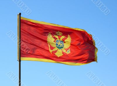 Flag of Montenegro on a blue sky