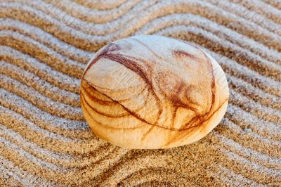 Stone on sand