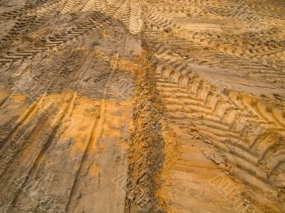 Car traces in sand