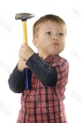 small boy is keeping hammer
