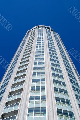 High modern building on background blue sky