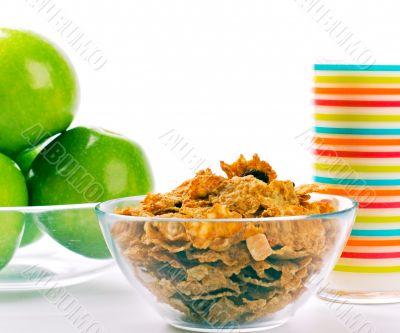 cornflakes, glass of milk and green apples