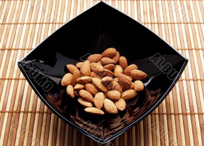 Almonds in black glance plate