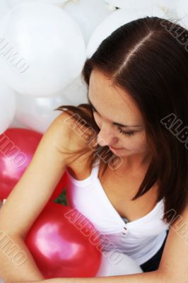 Young girl surrounded by balloons