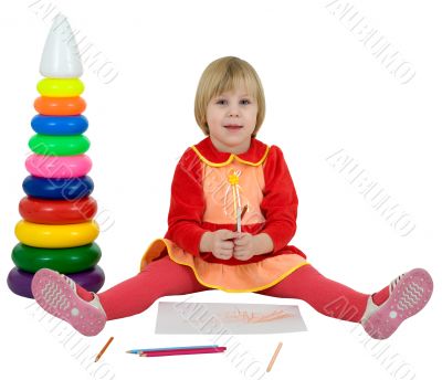 Little girl and toy pyramid and crayons