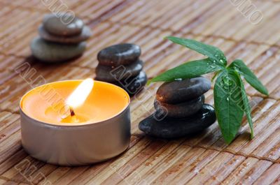 spa stones with leaf and candle