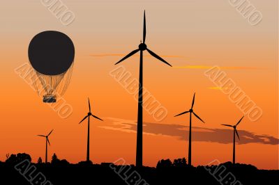 Wind generators and Air Baloon in sunrise