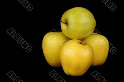Four yellow apples