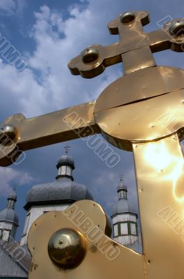 Huge golden christian cross near church