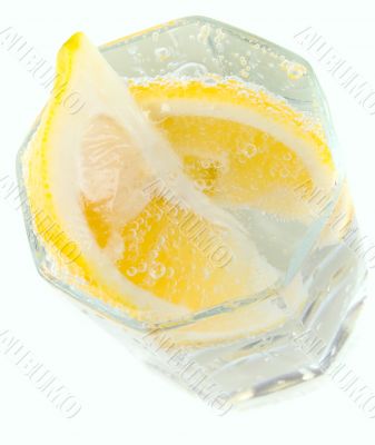 glass with soda water and lemon slices