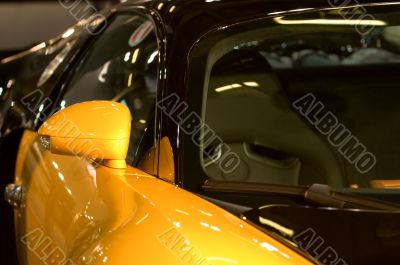 Right side mirror of shiny blue car