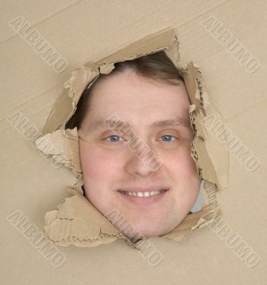 Male face look up through hole carton