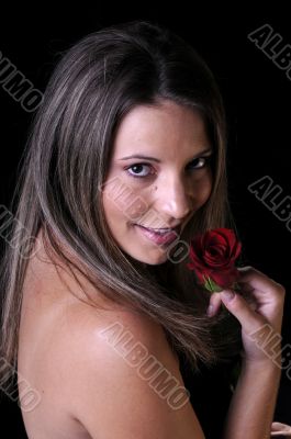 Beautiful young brunette woman with red rose