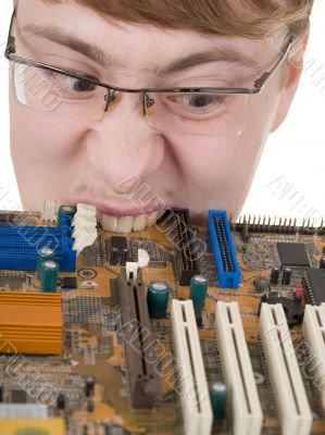 Guy bites an old circuit board