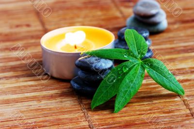 spa stones with leaf and candle