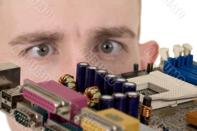 Man examines an electronic circuit