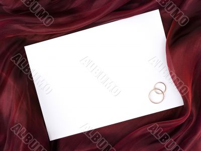white frame in silk and two wedding rings