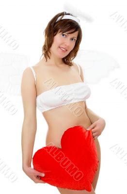 Young woman in angel`s costume with red heart