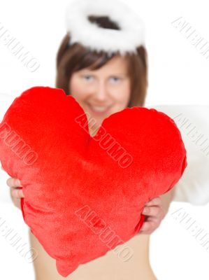 Young woman in angel`s costume with red heart