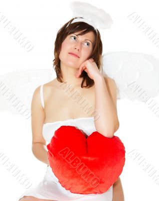 Young woman in angel`s costume with red heart