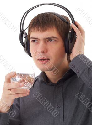 young man in headphones drinking water
