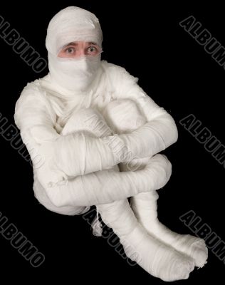 Egyptian mummy emo sitting on a black