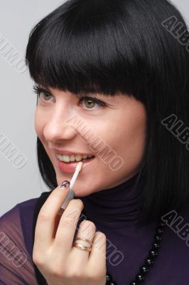 woman applying lipstick