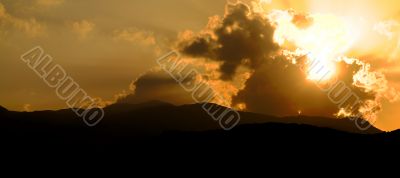 Dramatic sunset over the hills in the mist