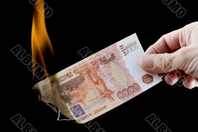 burning paper currency closeup