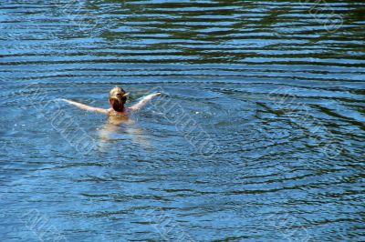 single female figure in wide water surface